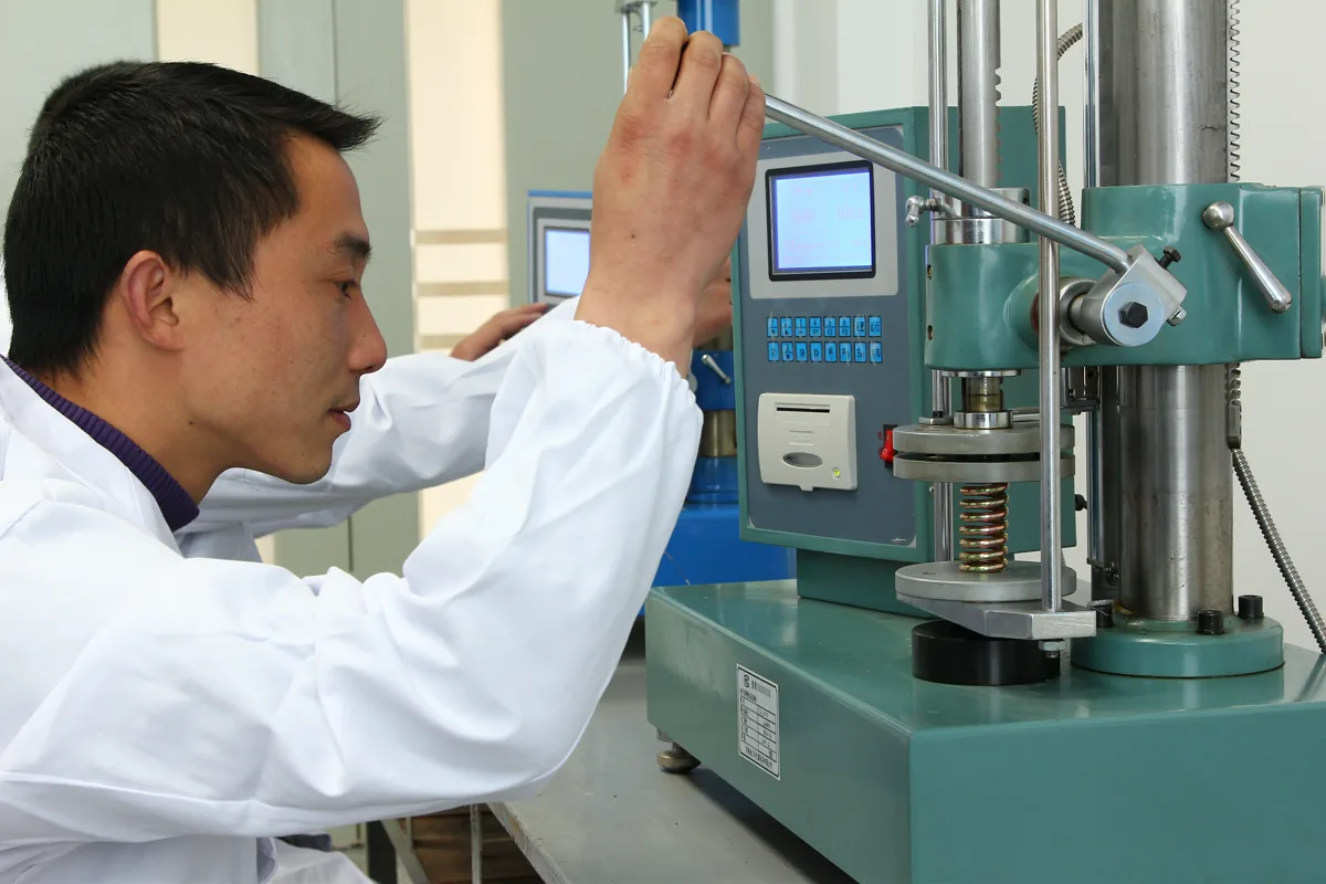 XMC operator working at a pneumatic component inspection station