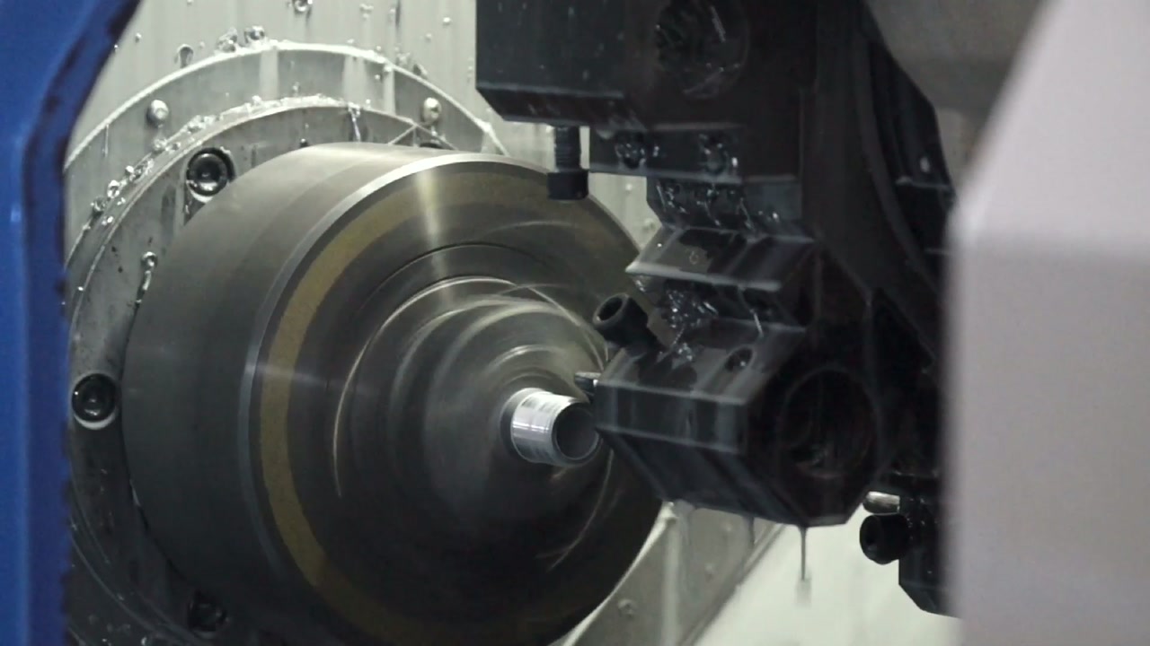 Supplied XMC workshop image showing a metal workpiece and a machining tool